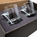 Two angled whiskey axe glasses in foam packaging for BenShot Fire Axe Glasses