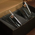 Two champagne flutes in a black foam box with a BenShot Pint Glass