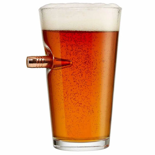 Amber beer in BenShot Pint Glass with a copper bullet embedded in the side