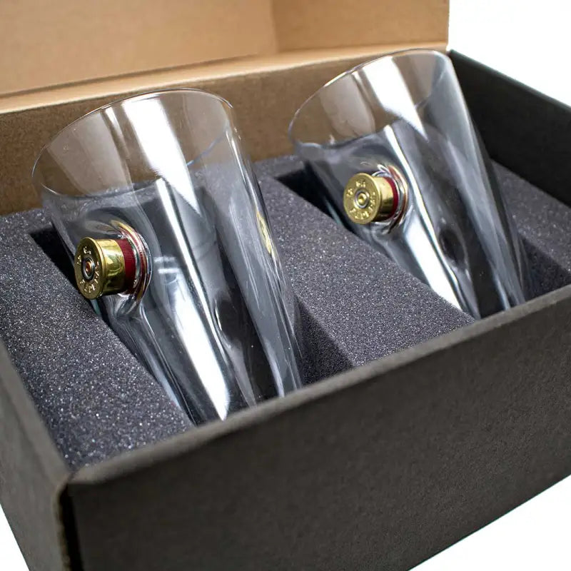 Two BenShot Shotgun Shell Glasses with embedded bullet designs in their bases