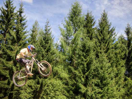 Mountain biker airborne with finger cut kit for safety and quick injury management