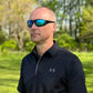 Person in black Under Armour polo wearing METEL M30 Safety glasses with blue mirror lens