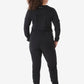 Black athletic jumpsuit with long sleeves and tapered legs for women’s long-sleeve scrub