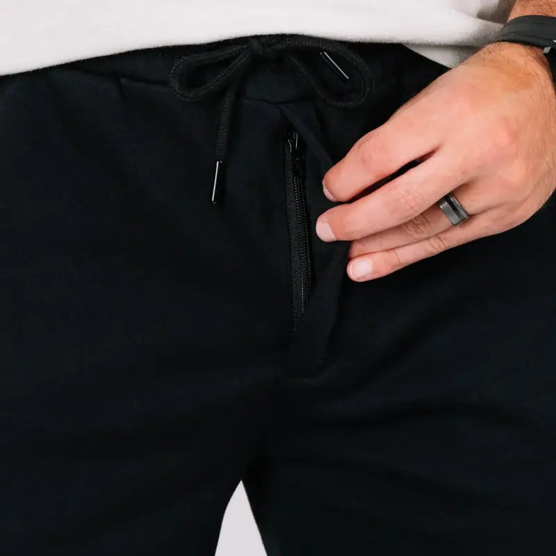 Black athletic pants with zippered pocket featuring patented Carrier Retention Waistband