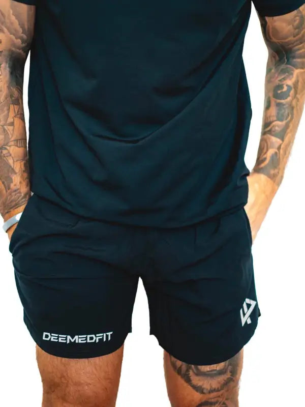 Black athletic shorts with DEEMEDFIT logo, part of Men’s Shorts Response collection