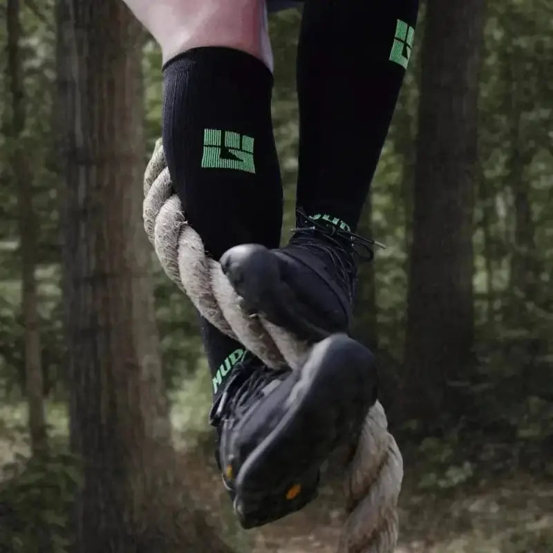 Black Athletic Tall Compression Socks with Neon Green Logo for Long Distance Courses