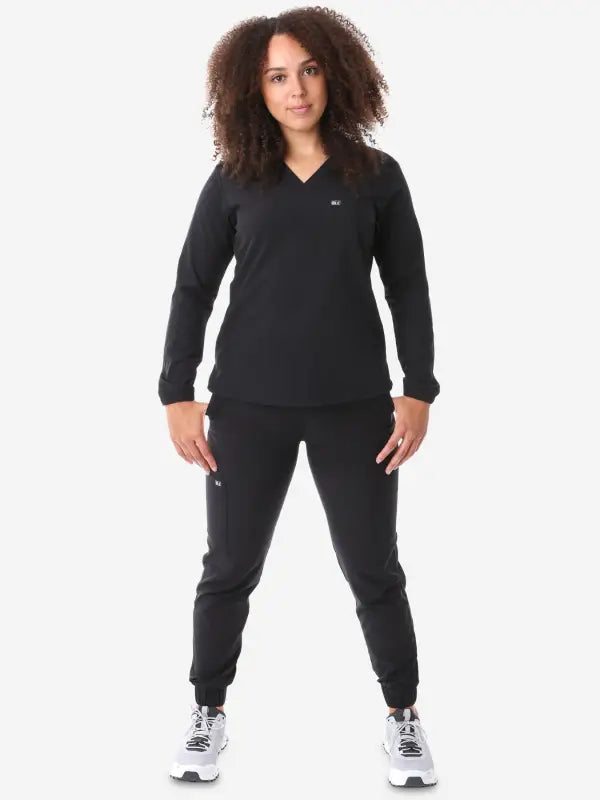 Black athletic tracksuit featuring a women’s long-sleeve scrub top with jogger pants