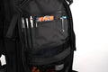 Black backpack with open front pocket and supplies, perfect for a discreet rifle backpack