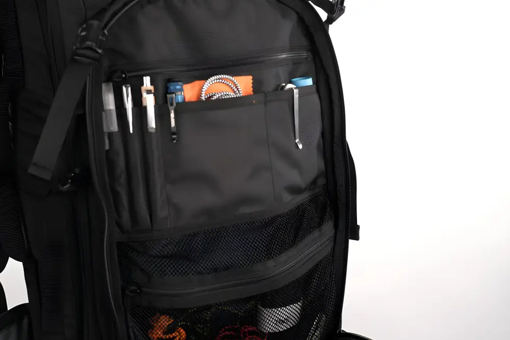 Black backpack with open front pocket and supplies, perfect for a discreet rifle backpack