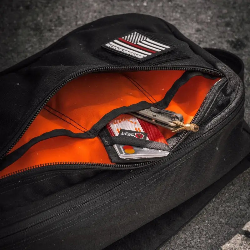 Black backpack with orange interior and American flag patch in 12hr Slate Grey 1000D Cordura