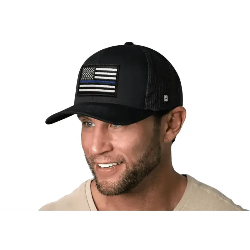 Black Police Snapback featuring a grayscale American flag patch on a blue line trucker hat