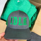 Black baseball cap featuring green IDLH font logo embroidery on the front