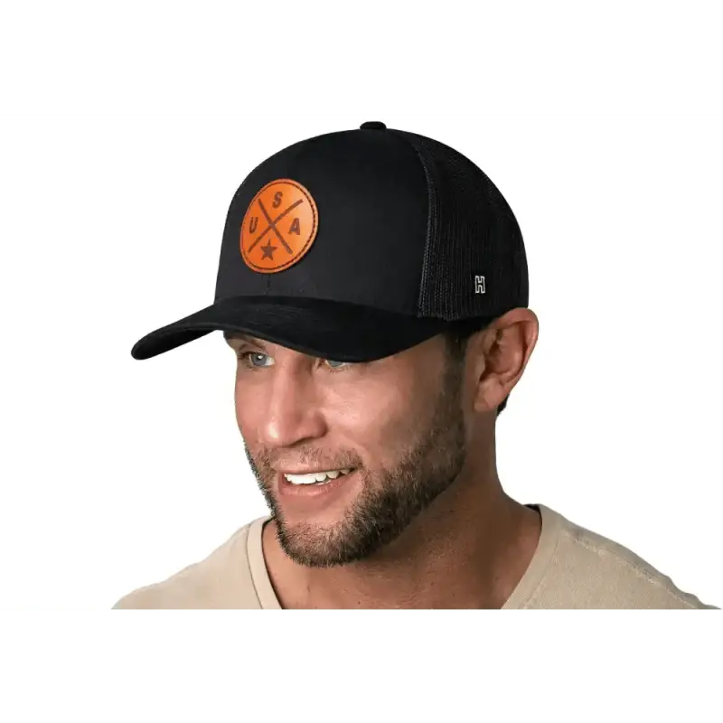 Black America Snapback featuring an orange patch logo on a USA Trucker Hat leather design