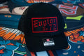 Black Richardson 112 trucker snapback with red embroidered English Passport patch