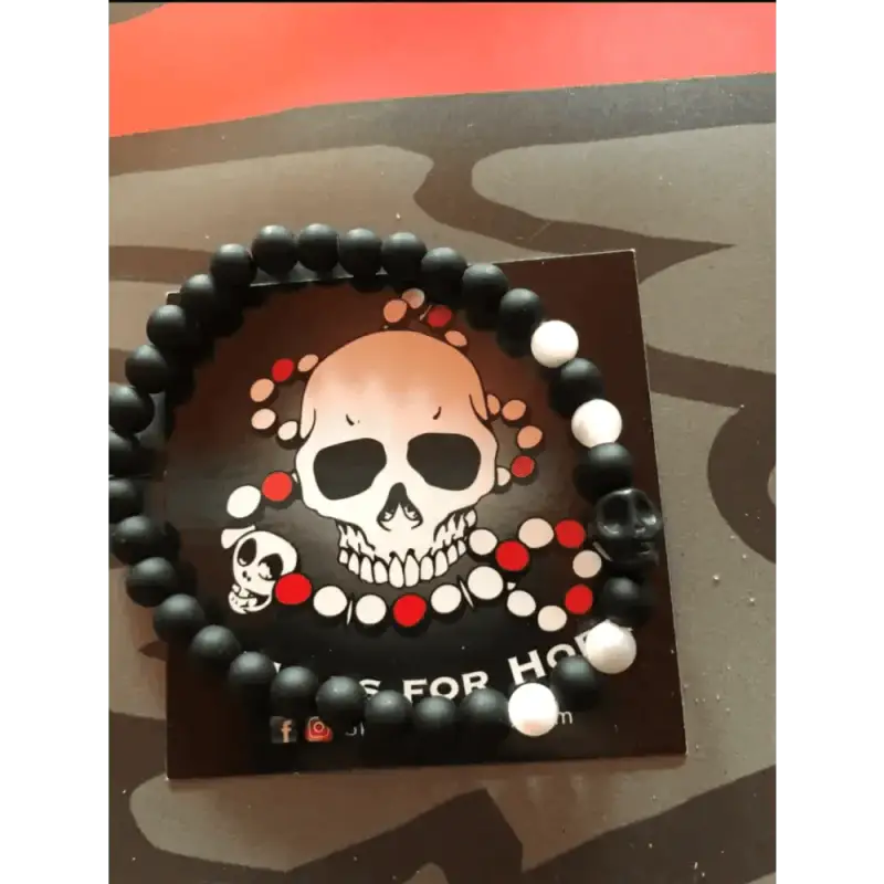 Black beaded Skull Mala Bracelet with skull design on card backing