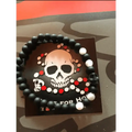 Black beaded Skull Mala Bracelet with skull design on card backing