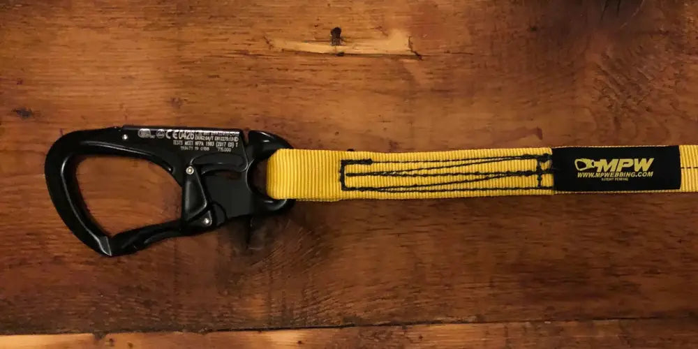Black carabiner with yellow webbing for personal carry and fireground applications