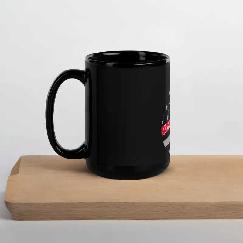 Black ceramic Chief Miller Black Glossy Mug on a rustic wooden surface