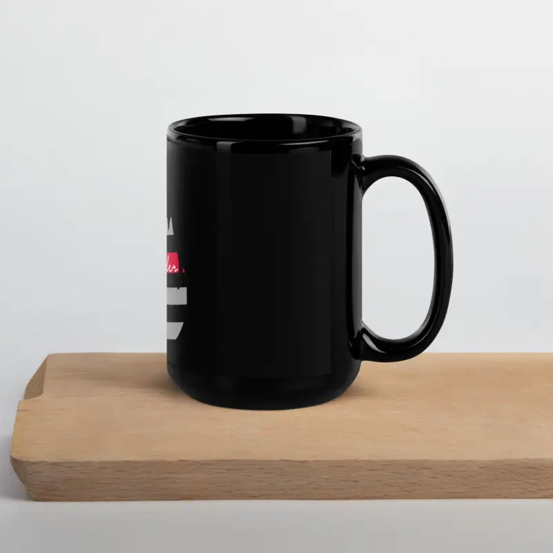 Black ceramic coffee mug on wooden surface, Chief Miller Black glossy design