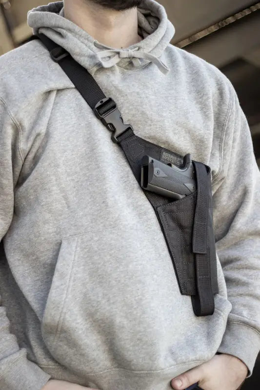 Black Military Shoulder Holster with HN45B Handgun over Gray Hoodie