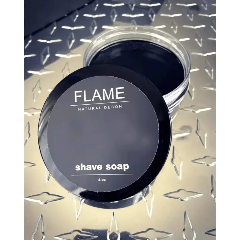 Black container of Flame brand shave soap with activated charcoal and removable lid