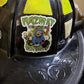 Black firefighter helmet with yellow reflective panels and HAZMAT sticker, perfect for Hazmat Mop helmet decal