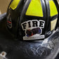 Black firefighter helmet with reflective panels and FIRE text for photographer helmet decal