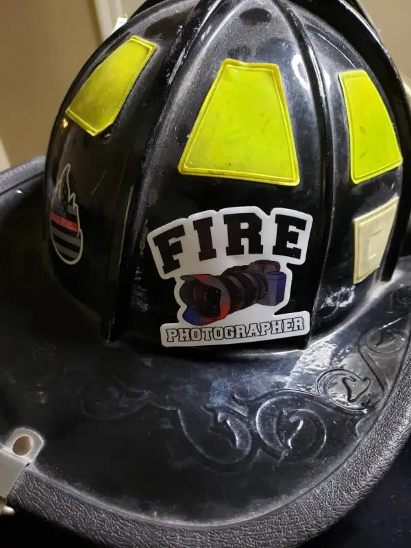 Black firefighter helmet with reflective panels and FIRE text for photographer helmet decal