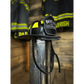 Black firefighter helmet with yellow reflective stripes and leather chin straps