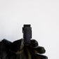 Black glove holding a dark electronic device from the Handy Hook Firefighter Set