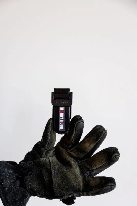 Black glove holding a dark USB flash drive from Handy Hook Firefighter Set