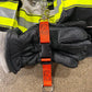 Black firefighting gloves on an orange glove strap for first responders safety