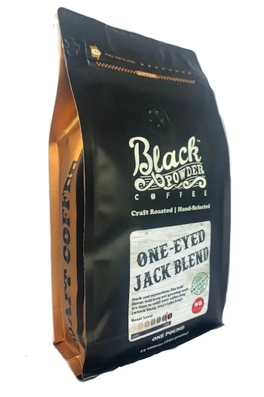 Black and gold pouch of One-Eyed Jack Blend naturally grown dark roast coffee beans with roast level and one pound weight