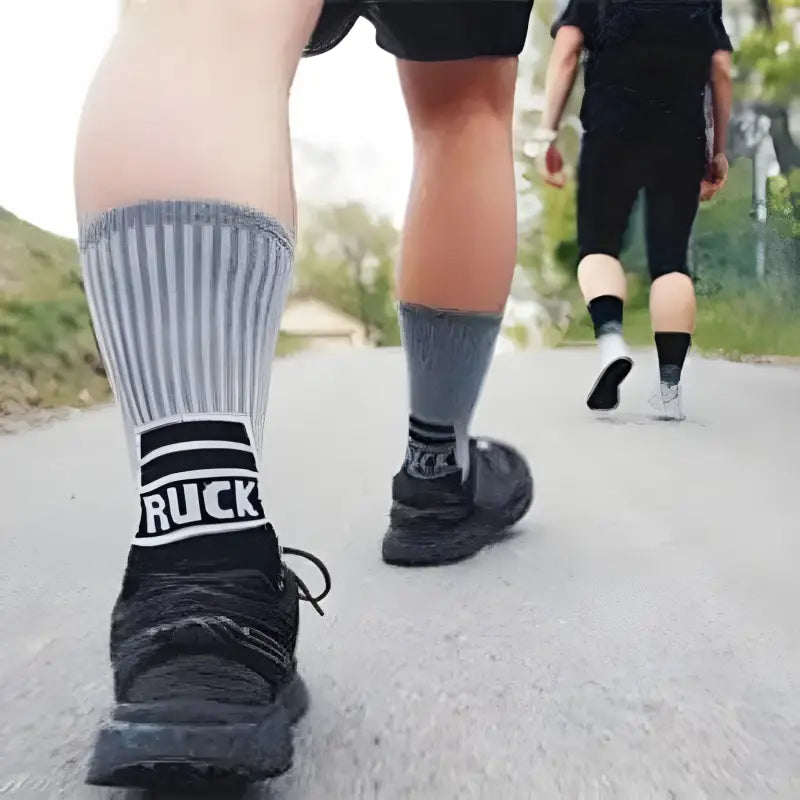 Black and gray striped MudGear Ruck Sock with RUCK text worn with black shoes