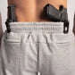 Black handgun tucked in Carrier Sweatpants - Carbon Grey with patented carrier retention