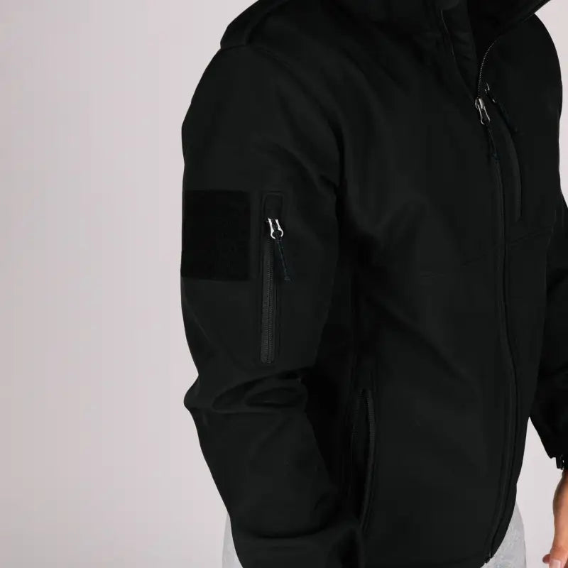 Black Tactical Jacket Alpha with convenient hand pocket on sleeve for versatile wear