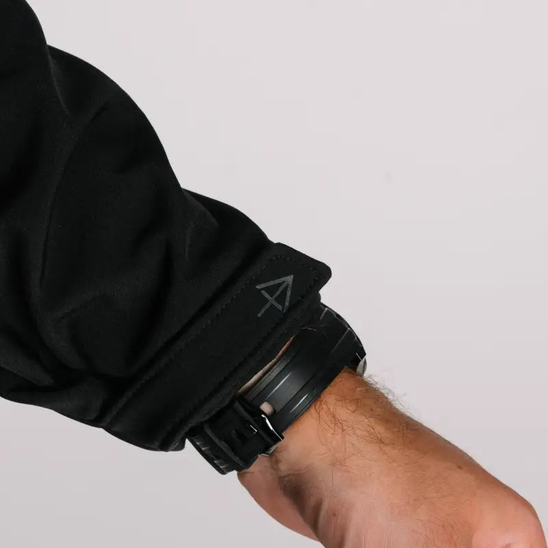 Black jacket sleeve with watch showing tactical jacket Bravo hand pocket feature