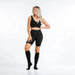 Black knee-high compression socks with matching athletic shorts and crop top for marathon