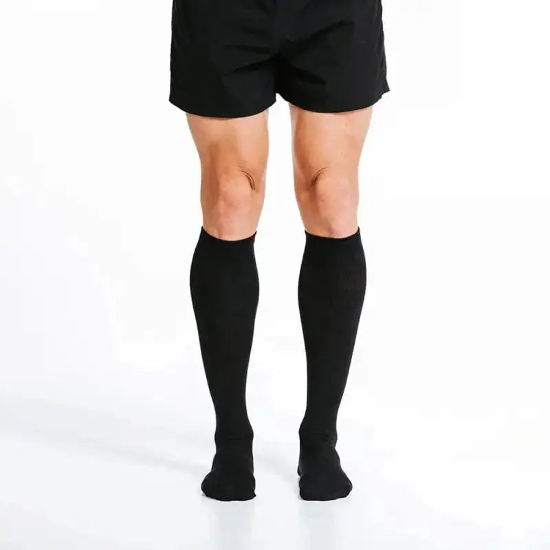 Black knee-high compression socks paired with black shorts for marathon runners