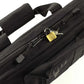 Black laptop bag with brass padlock for secure deluxe pistol case storage