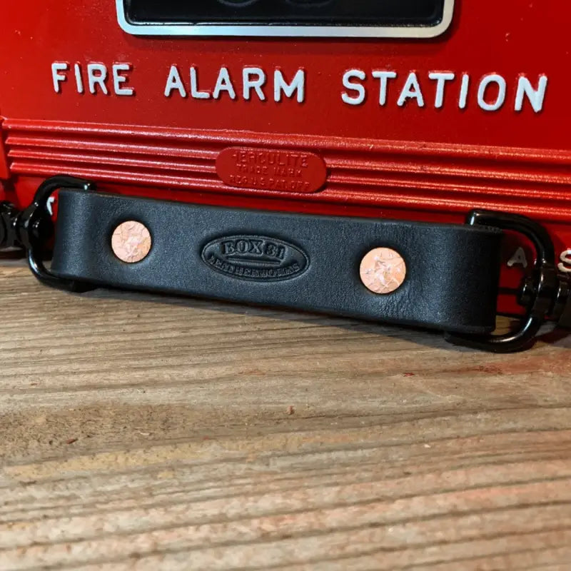 Black leather anti-sway strap bracelet with copper rivets for radio strap combos