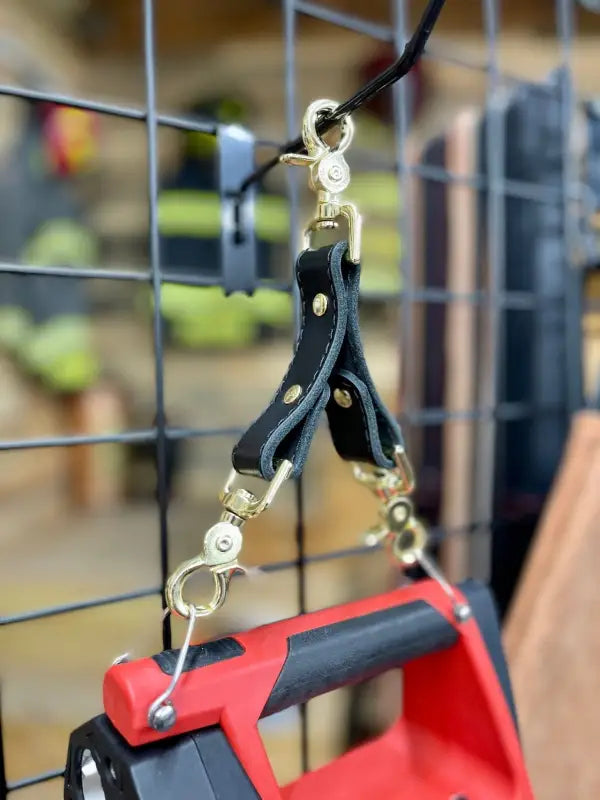 Black leather strap with metal clips for Box Light Clip hanging on a wire