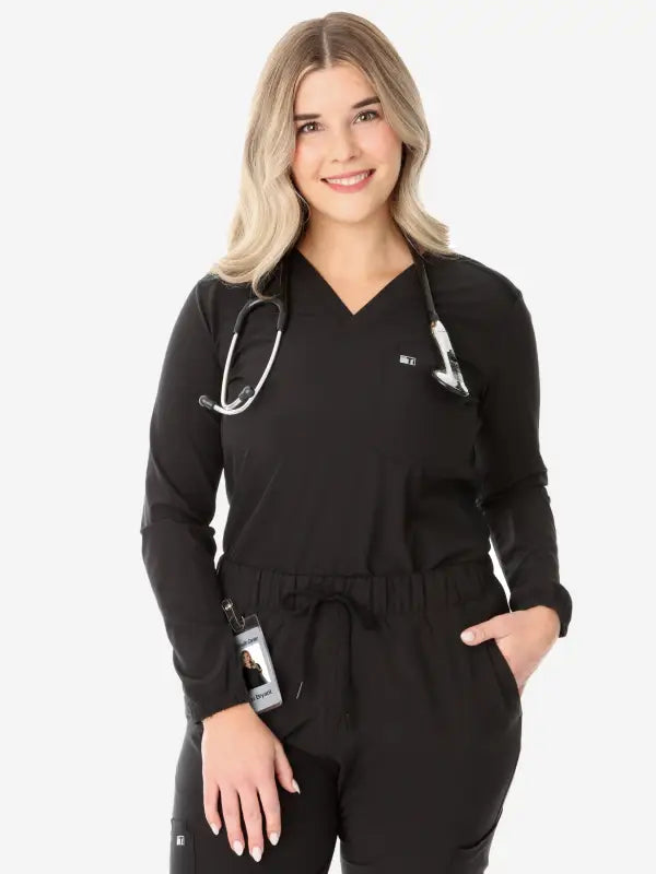 Black women’s long-sleeve scrub top with a stethoscope draped around the neck