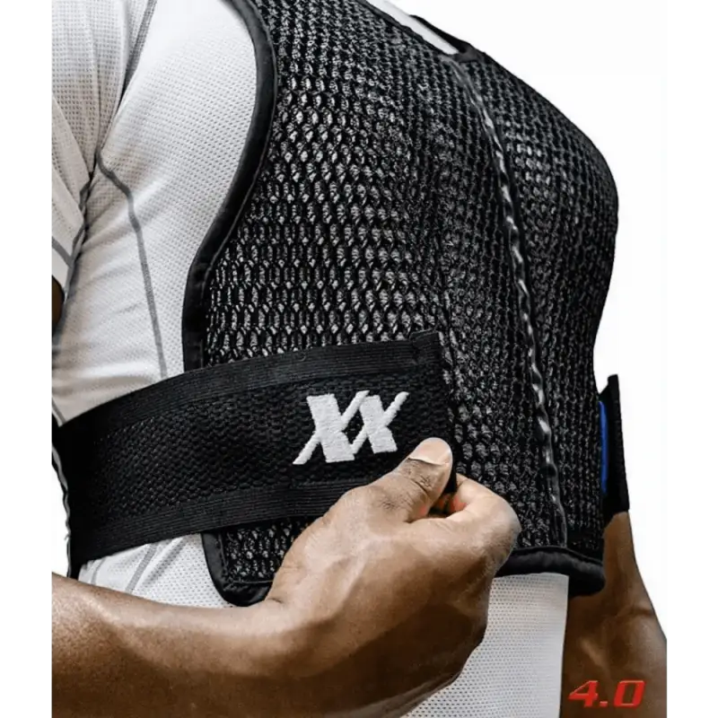 Black mesh Maxx-Dri Vest 4.0 with adjustable fit and XX branding being fastened