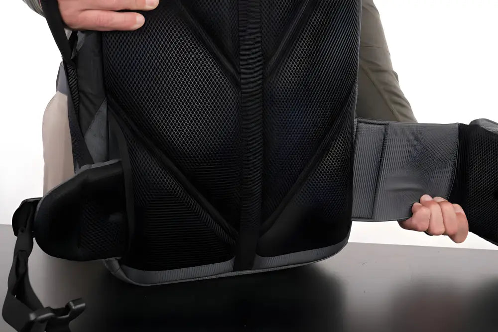 Black mesh office chair with armrests beside SUMMIT Discreet Rifle Backpack and pouch