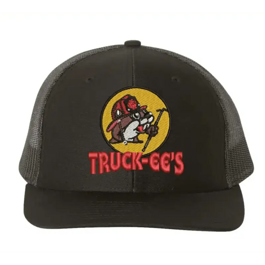 Black mesh fitted trucker hat with Truck-ee’s logo patch featuring a raccoon and dog