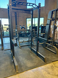 Black metal power rack for strength training and squat exercises in SFE Commercial series