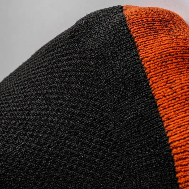 Black and orange knitted winter beanie with MudGear Quarter Crew Socks for trail use