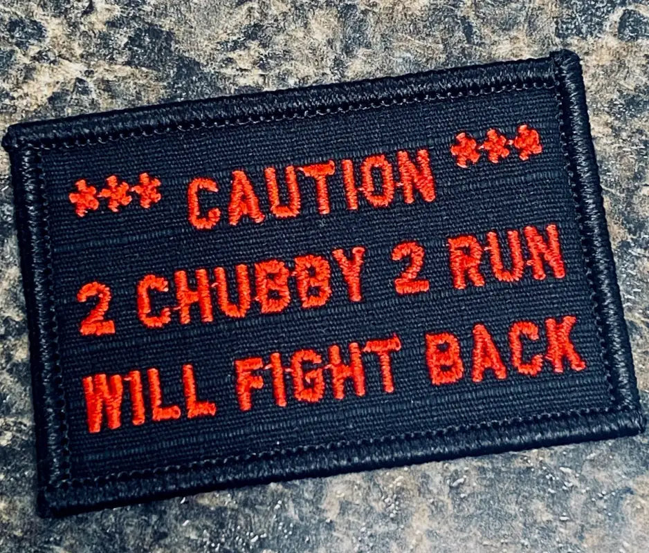 Black w red 2x3 patch with embroidered text reading CAUTION 2 CHUBBY 2 RUN WILL FIGHT BACK
