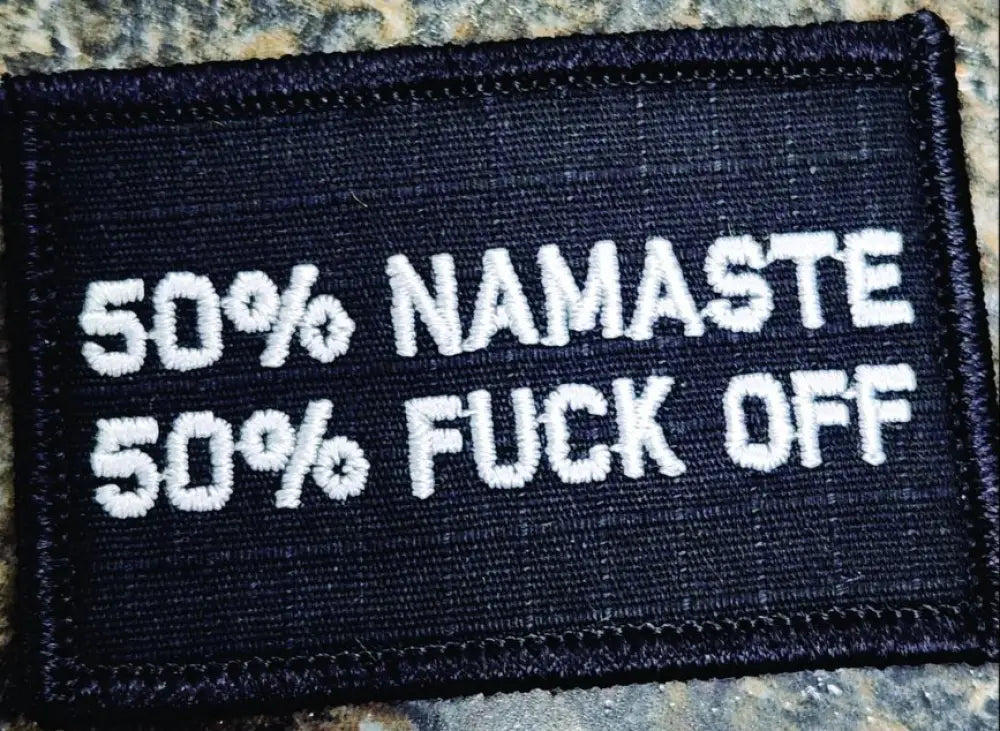 Black w silver 2x3 patch with text reading 50% Namaste 50% F*ck Off design